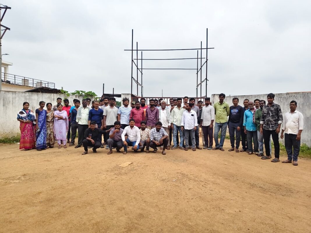 Workers stage a sit-in in front of the KJL Poultry gate.